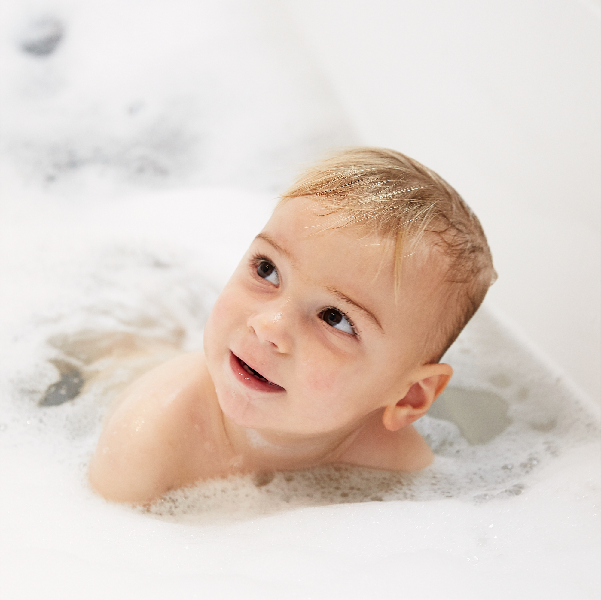Baby boy in bubble bath after Seven Sundays baby wash product was used to make bubbles